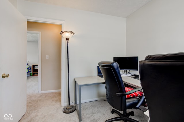 office featuring light colored carpet and a textured ceiling