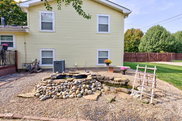 rear view of property with central AC unit