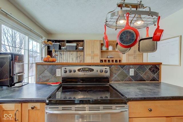 kitchen featuring decorative backsplash, a textured ceiling, electric range, and light brown cabinetry