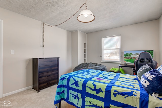 bedroom featuring a textured ceiling and light carpet