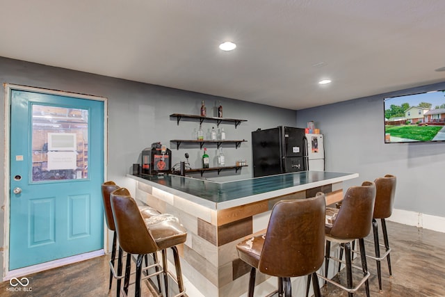 bar with black refrigerator and white refrigerator