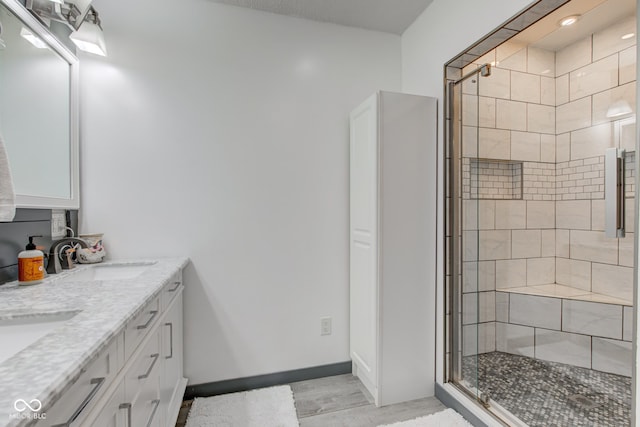 bathroom with vanity and a shower with shower door