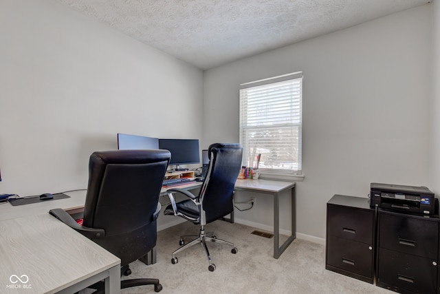 carpeted office space with a textured ceiling