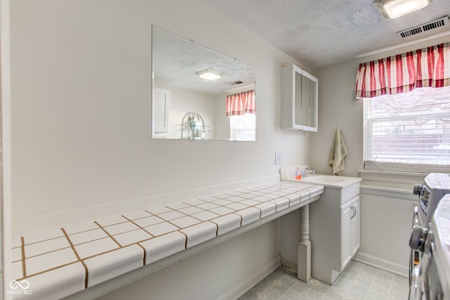 interior space featuring a textured ceiling and sink