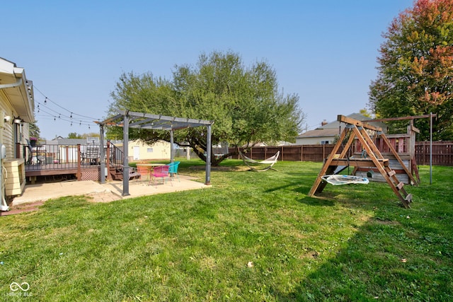 view of yard with a pergola, a wooden deck, and a patio