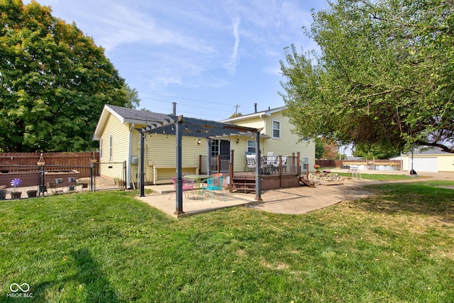 rear view of house with a yard, a pergola, a patio area, and a wooden deck