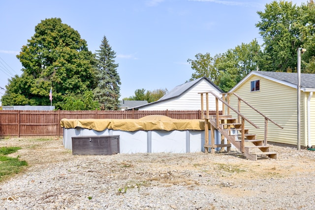 back of house featuring a covered pool