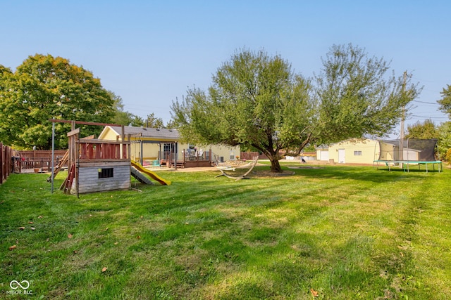 view of yard with a playground and a trampoline