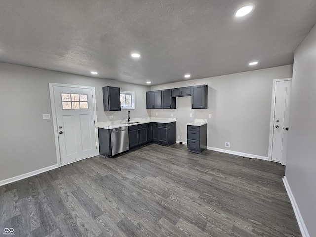 kitchen with gray cabinetry, dishwasher, sink, dark hardwood / wood-style floors, and a textured ceiling