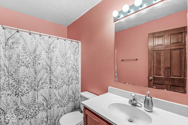 bathroom featuring vanity, curtained shower, toilet, and a textured ceiling