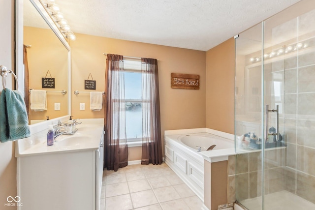 bathroom featuring vanity, plus walk in shower, tile patterned flooring, and a textured ceiling