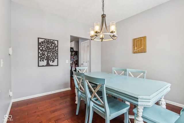 dining room featuring dark hardwood / wood-style floors and a notable chandelier