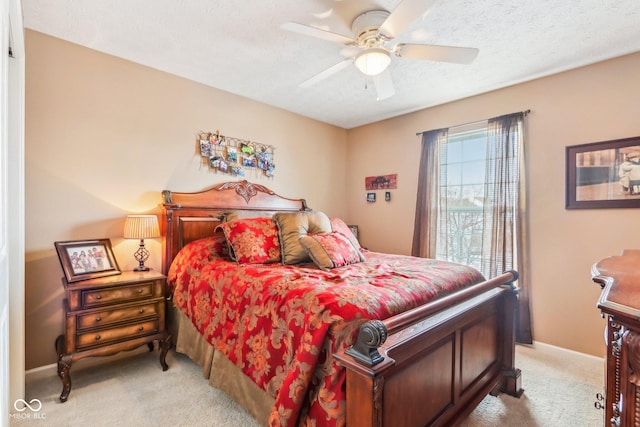 bedroom with light carpet, ceiling fan, and a textured ceiling