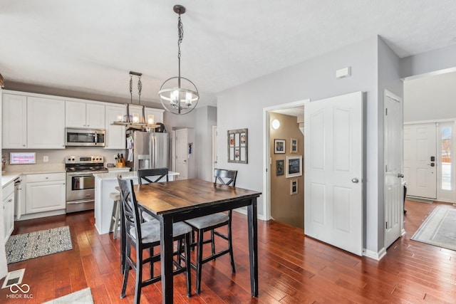 dining room featuring an inviting chandelier and dark hardwood / wood-style floors