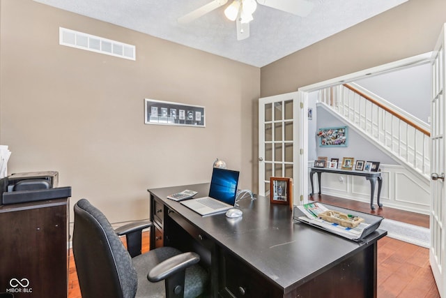 office with wood-type flooring, a textured ceiling, and ceiling fan