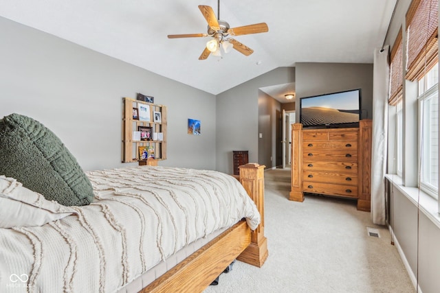 bedroom with lofted ceiling, light colored carpet, and ceiling fan