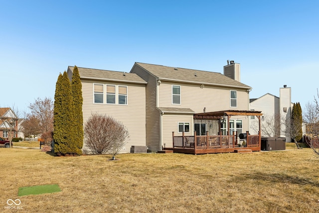 back of house featuring a yard, a pergola, and a deck