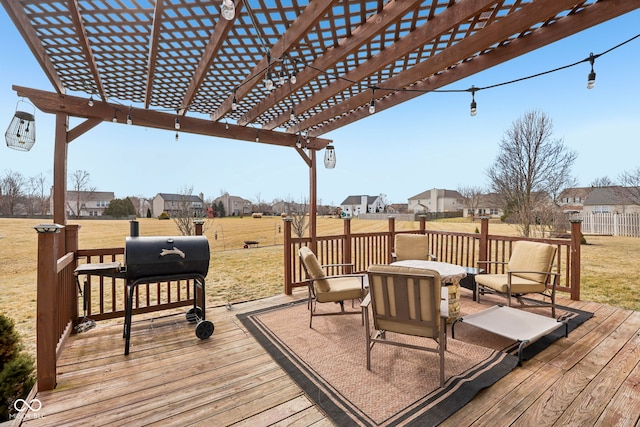 wooden terrace with area for grilling, a pergola, and a lawn