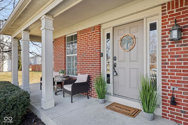 view of exterior entry featuring covered porch