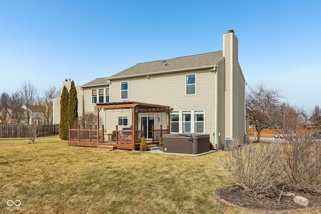 back of property featuring a yard, a hot tub, central air condition unit, and a deck