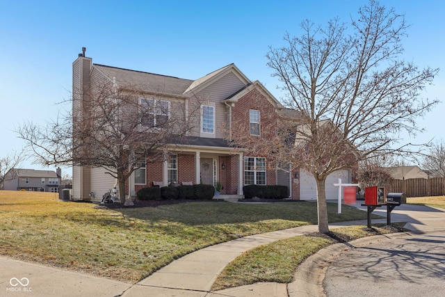 view of front of house featuring a garage, central AC, and a front lawn