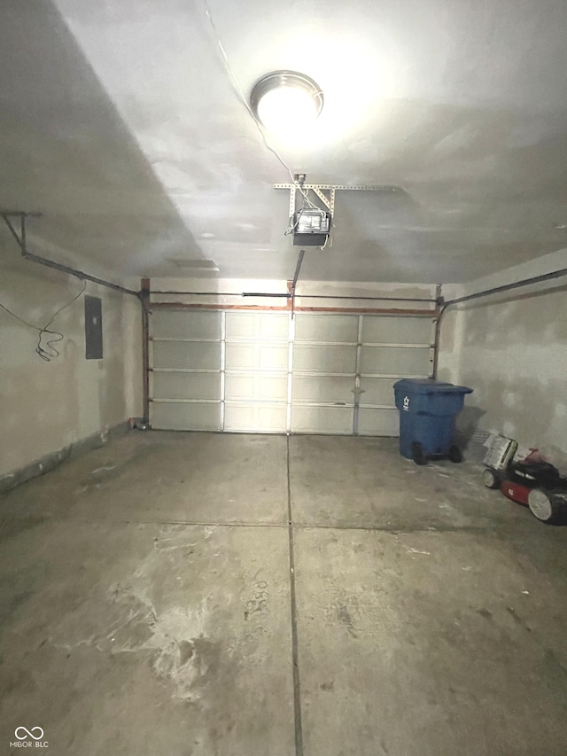 garage with electric panel and a garage door opener