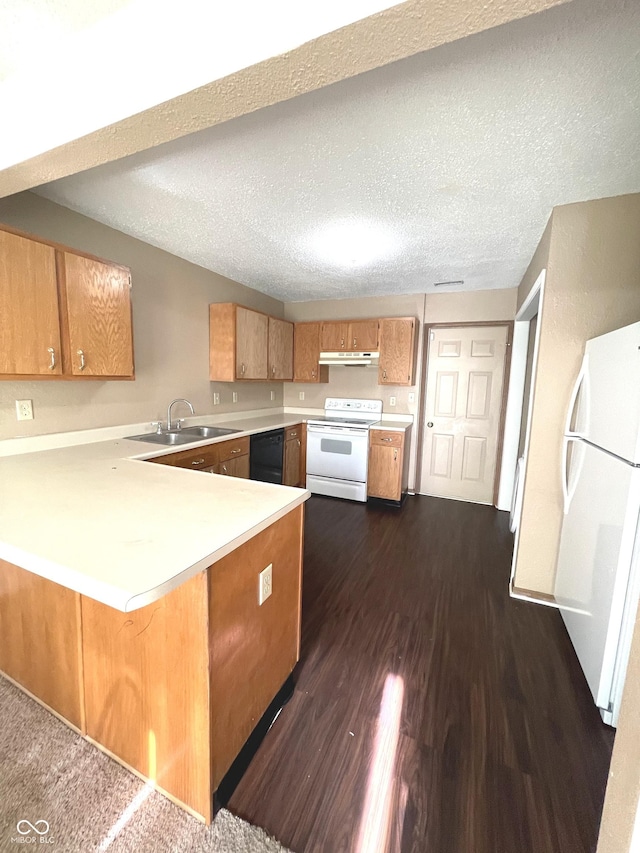 kitchen featuring sink, dark hardwood / wood-style floors, kitchen peninsula, a textured ceiling, and white appliances