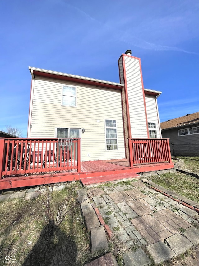 rear view of house featuring a wooden deck