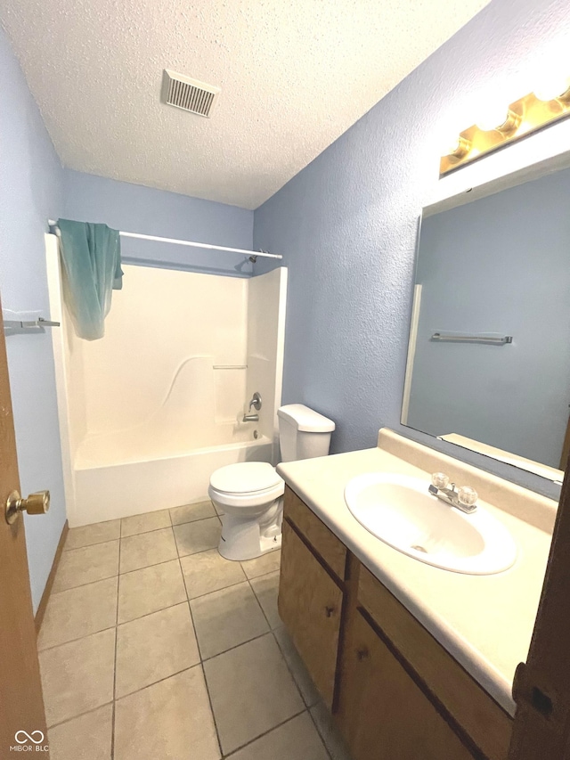 full bathroom featuring tile patterned flooring, shower / bath combination, a textured ceiling, toilet, and vanity