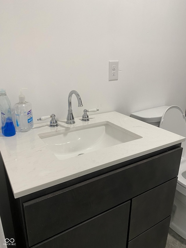 bathroom featuring toilet and vanity