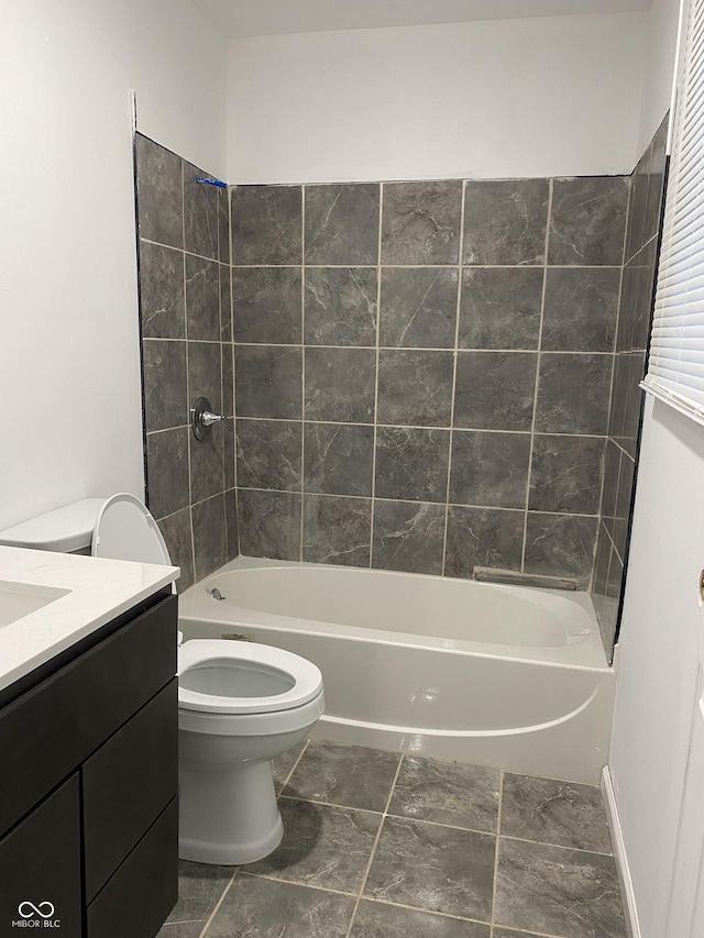 full bathroom featuring vanity, toilet, and tiled shower / bath combo