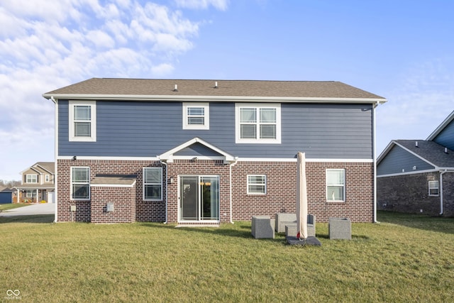 rear view of property with a lawn and central AC unit