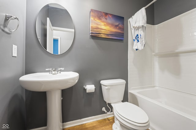 bathroom with toilet and shower / bath combo with shower curtain