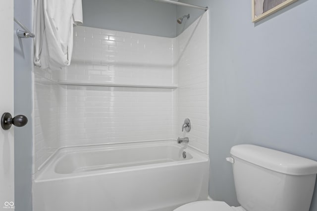 bathroom featuring shower / bath combination and toilet