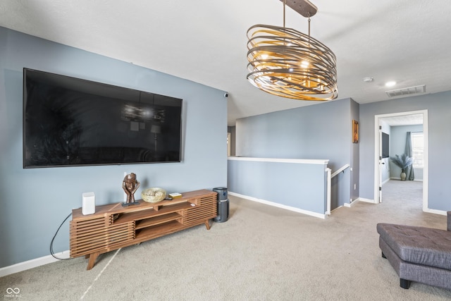 living area with carpet and an inviting chandelier