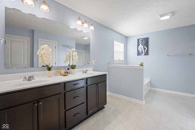 bathroom with tile patterned floors, vanity, a textured ceiling, and shower with separate bathtub