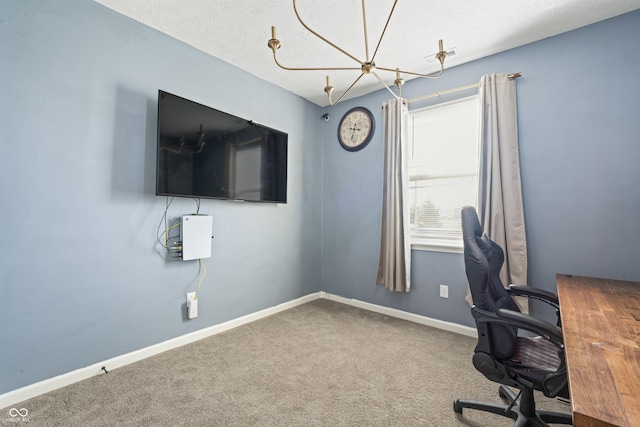 unfurnished office featuring carpet flooring and a textured ceiling