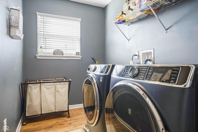 washroom with hardwood / wood-style flooring and independent washer and dryer