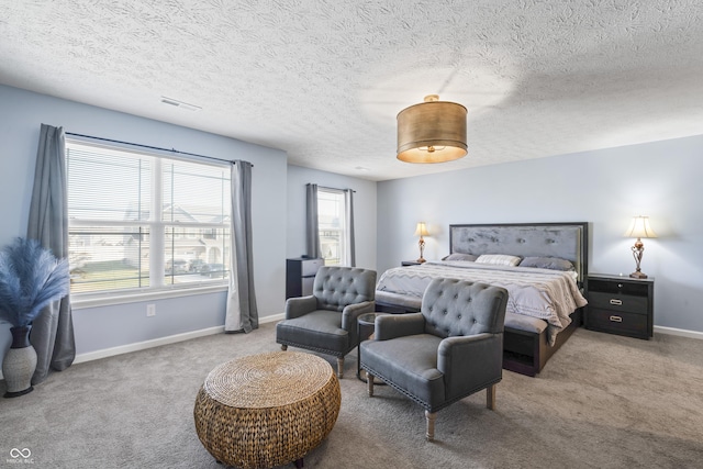 bedroom featuring carpet flooring and a textured ceiling