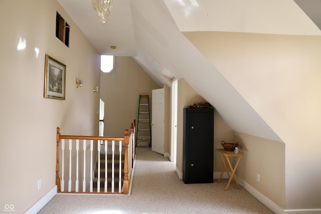 additional living space with vaulted ceiling, carpet flooring, and baseboards