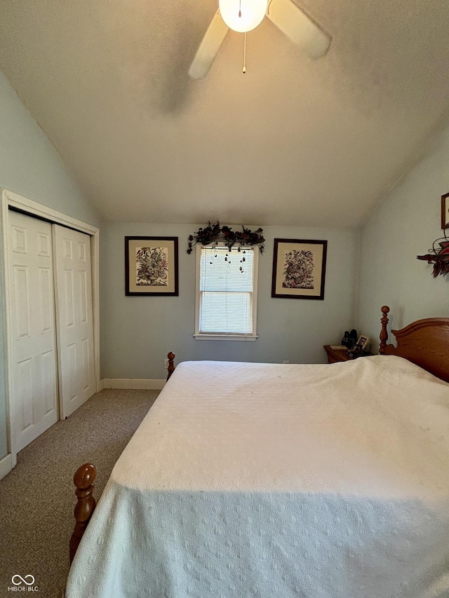 bedroom with a ceiling fan, carpet, a closet, and vaulted ceiling