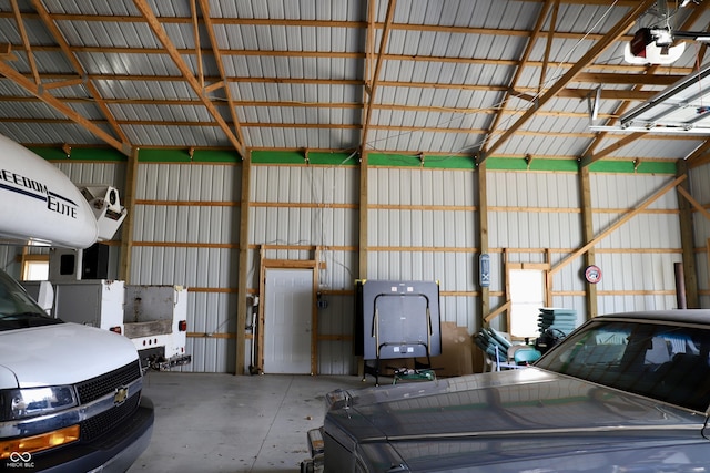 garage featuring a garage door opener and metal wall