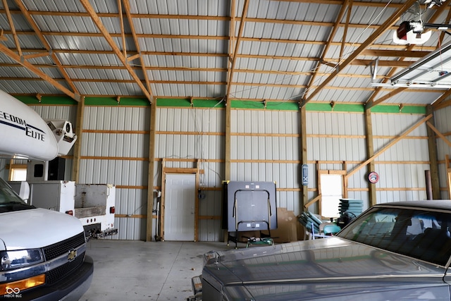 garage with metal wall and a garage door opener