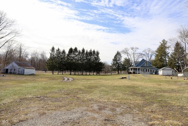 view of yard featuring an outbuilding and fence