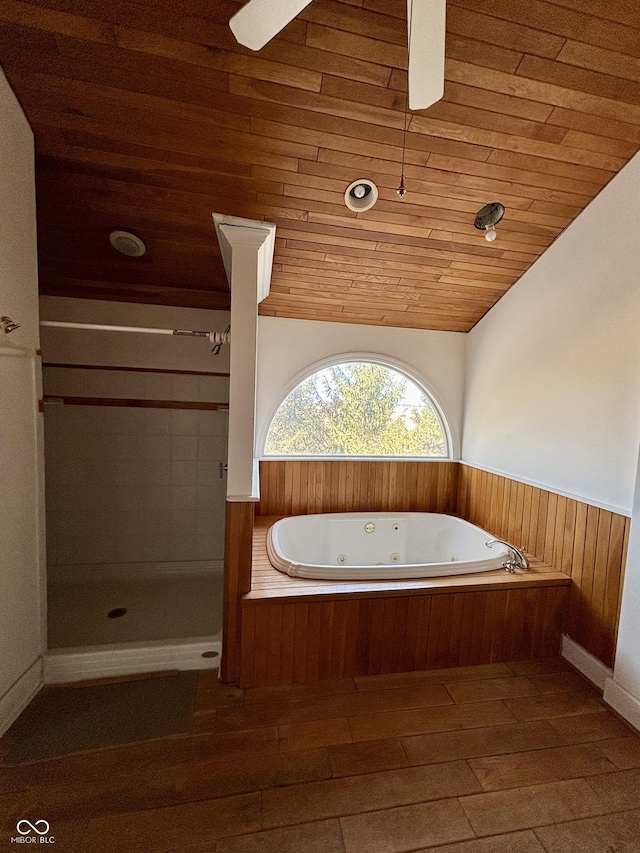 full bathroom with lofted ceiling, wooden ceiling, a wainscoted wall, wood finished floors, and a tub with jets