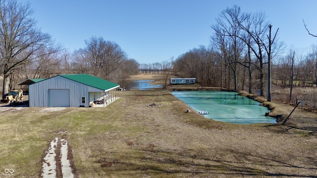 view of swimming pool featuring a lawn and a covered pool