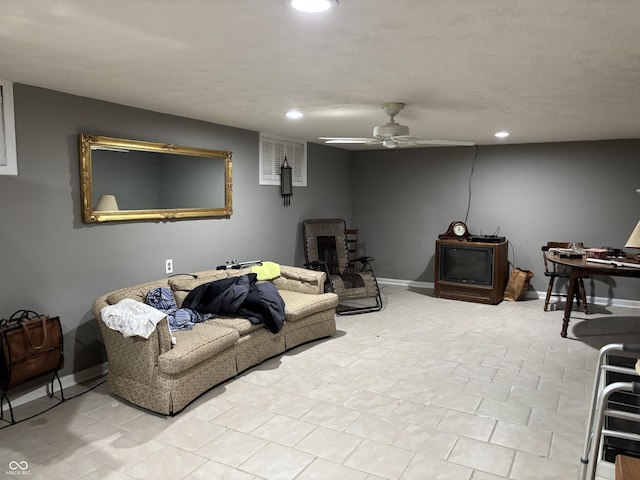 living area with baseboards, a ceiling fan, and recessed lighting