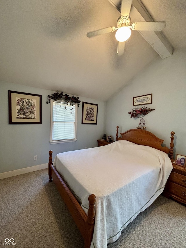 carpeted bedroom featuring lofted ceiling with beams, ceiling fan, a textured ceiling, and baseboards