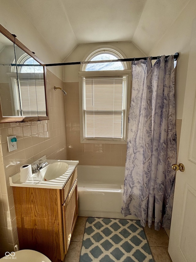 full bathroom with lofted ceiling, shower / tub combo with curtain, and tile patterned floors