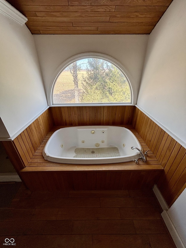 full bathroom with a wainscoted wall, wood ceiling, and a wealth of natural light